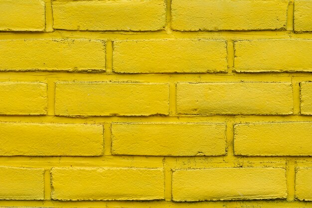Priorità bassa gialla astratta del muro di mattoni