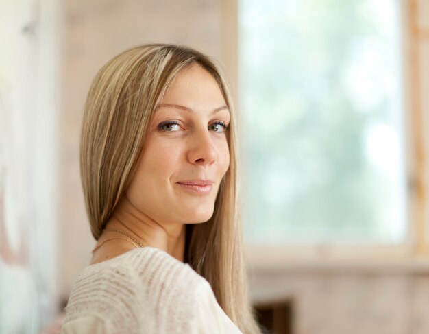 Ragazza bionda dai capelli lunghi in casa