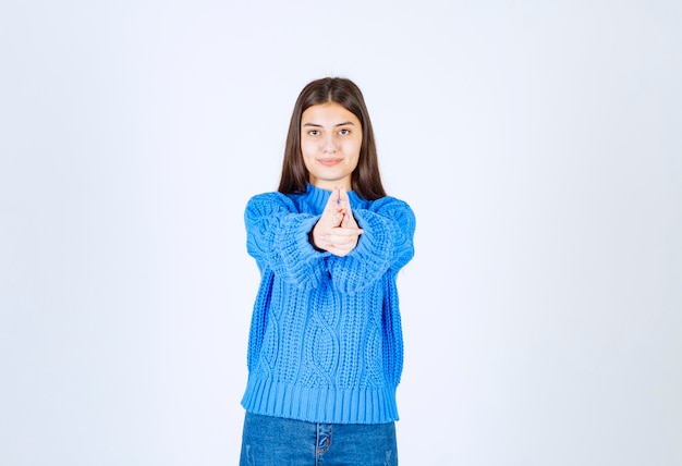 ragazza carina che punta davanti su bianco.