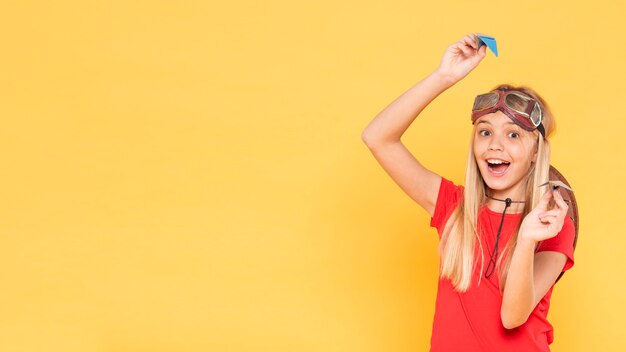 Ragazza che gioca con l'aeroplano di carta