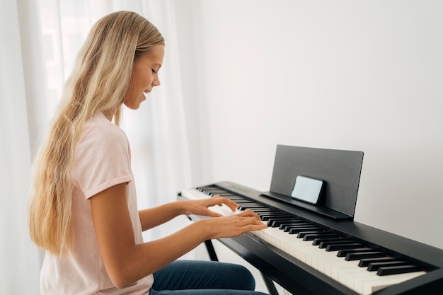 Ragazza che gioca strumento a tastiera a casa