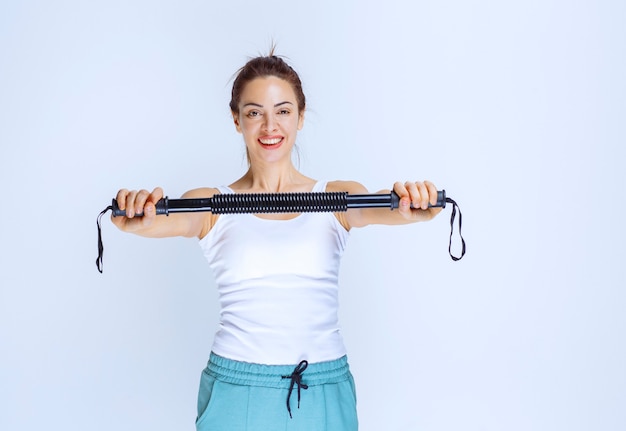 Ragazza che lavora con il bastone di karate e si diverte.