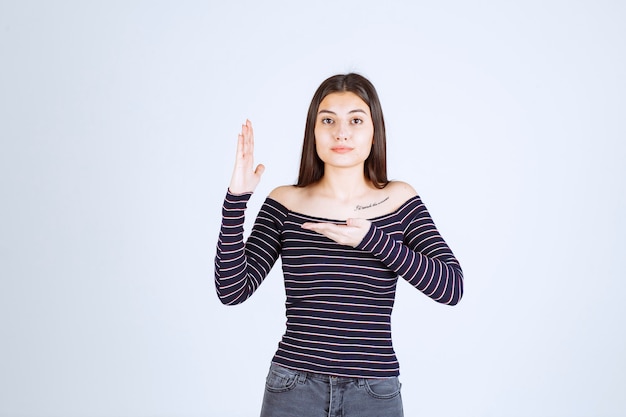 Ragazza che mostra qualcosa nella sua mano aperta.