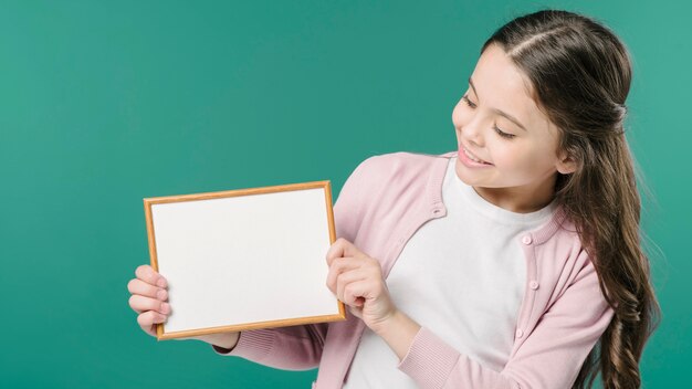 Ragazza che tiene la cornice vuota