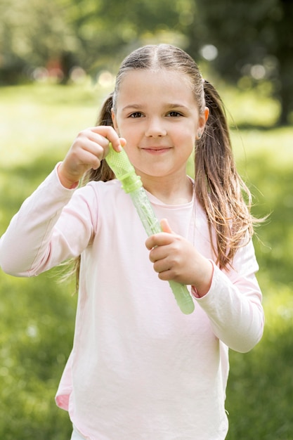 Ragazza che tiene un giocattolo verde