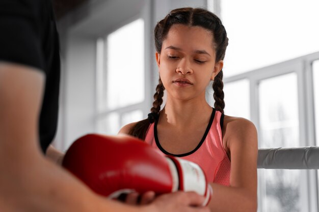 Ragazza del tiro medio che impara la boxe