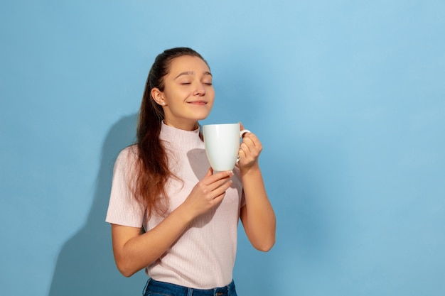 Ragazza dell'adolescente che gode del caffè