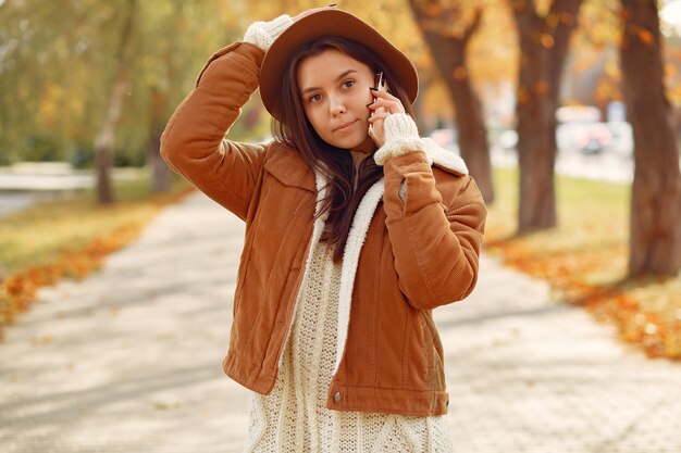 Ragazza elegante e alla moda in un parco in autunno