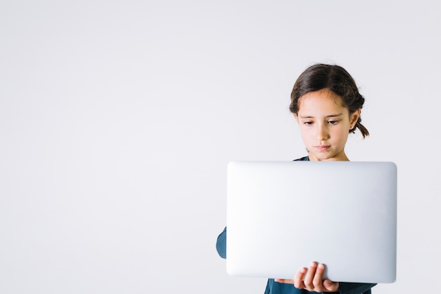 Ragazza seria che per mezzo del computer portatile