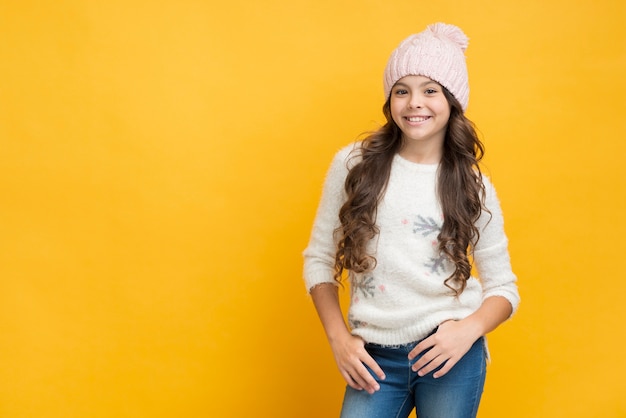 Ragazza sorridente in maglione con i fiocchi di neve