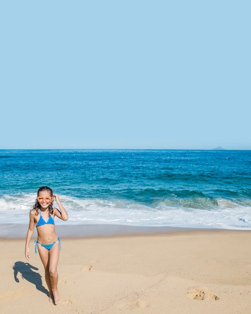 Ragazza sulla spiaggia con gli occhiali di protezione