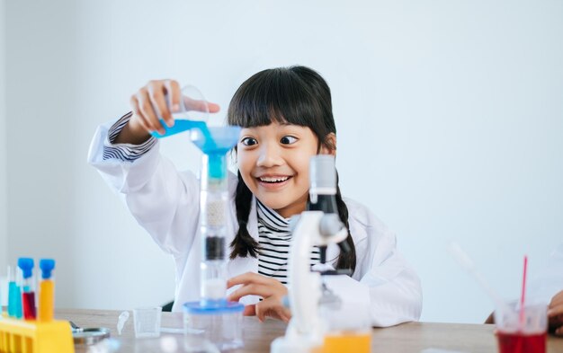 Ragazze che fanno esperimenti scientifici in laboratorio. Messa a fuoco selettiva.