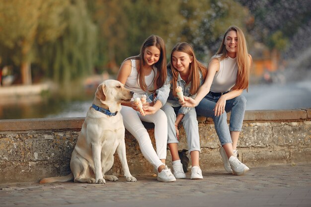 Ragazze che si siedono in una città di primavera con cane carino