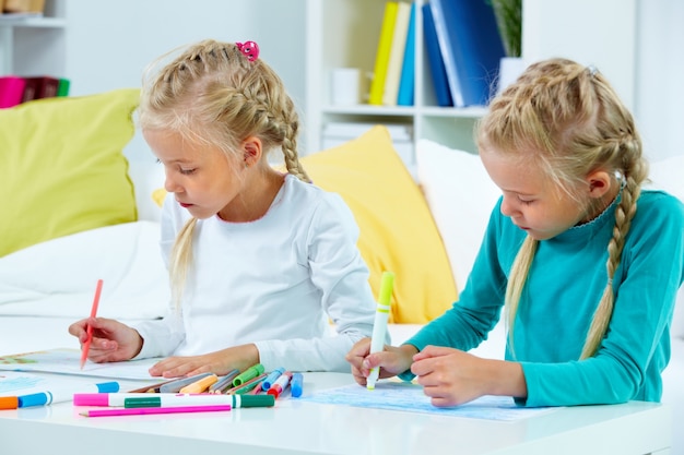 Ragazze disegno nel loro quaderno