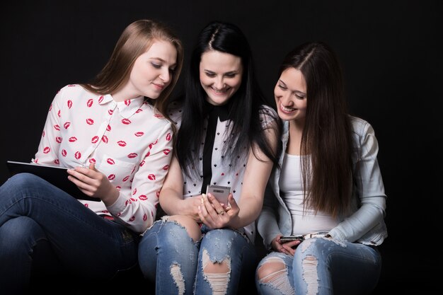 Ragazze sorridenti whilen guardando un cellulare