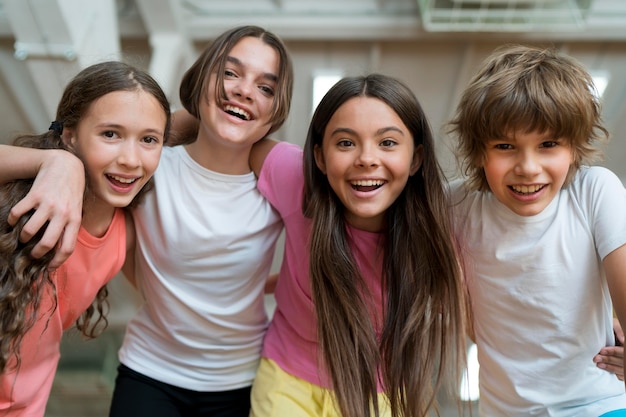 Ragazzi sorridenti di tiro medio in palestra