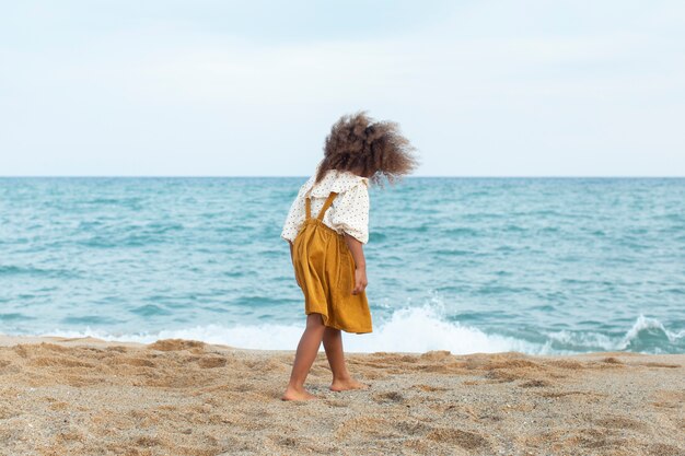 Ragazzo a tutto campo che si diverte in spiaggia