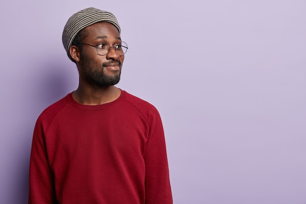 Ragazzo afroamericano che indossa camicia rossa e cappello alla moda