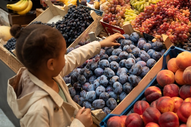 Ragazzo di tiro medio che sceglie la frutta