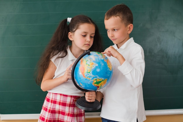 Ragazzo e ragazza che studiano la geografia