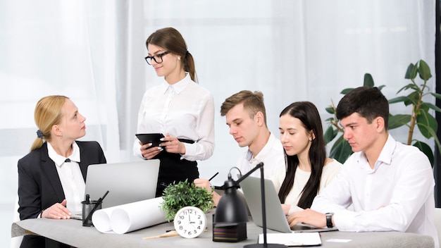 Responsabile femminile che discute il progetto con i suoi colleghi nell&#39;ufficio