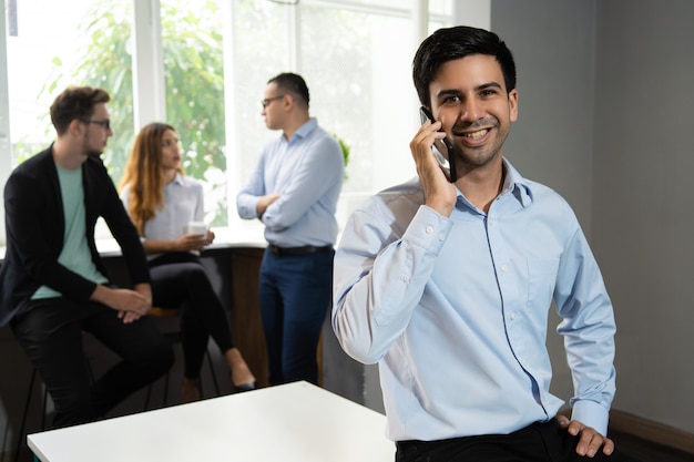 Responsabile sorridente che parla sul telefono cellulare