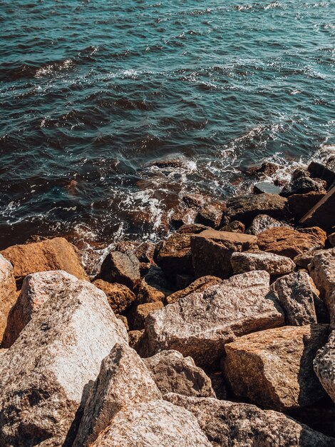 Ripresa verticale delle onde che raggiungono la costa rocciosa