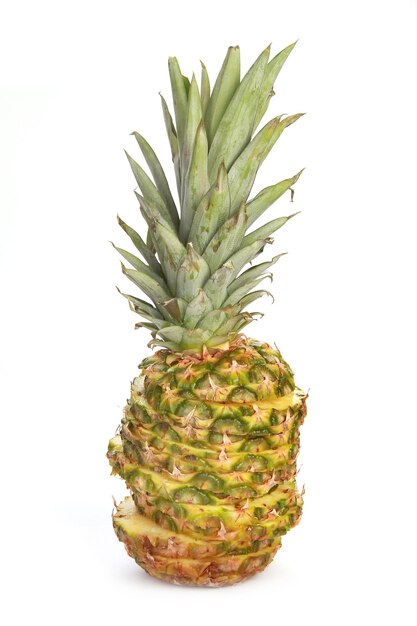 Ripresa verticale di un ananas tagliato con pezzi impilati isolati su sfondo bianco