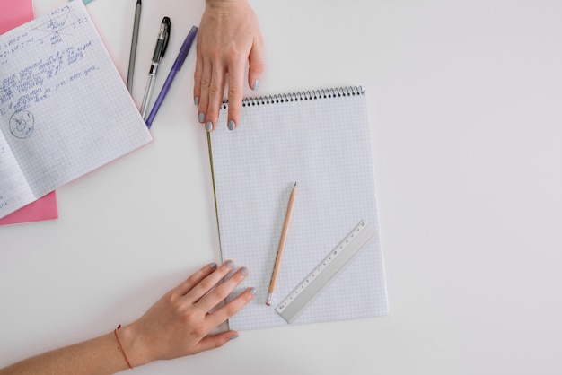 Ritagli le ragazze che presentano con il blocchetto per appunti