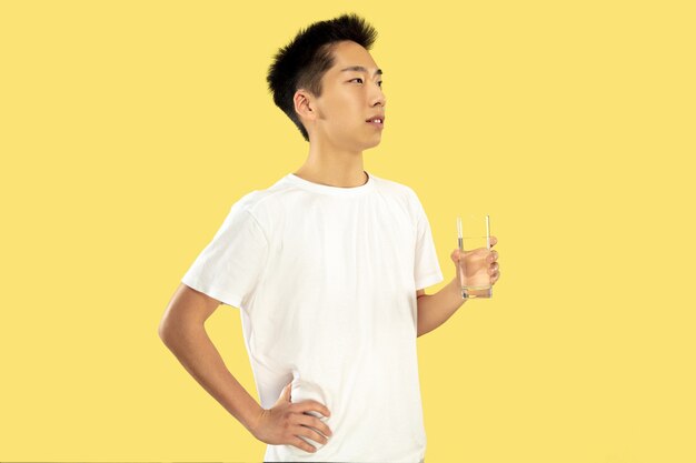 Ritratto a mezzo busto del giovane coreano su colore giallo