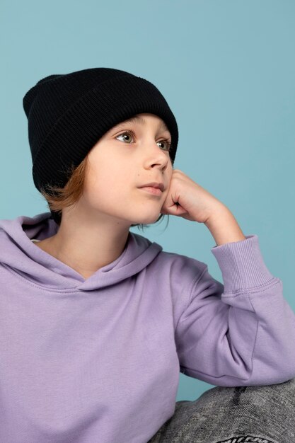 Ritratto del ragazzo teenager che posa e che pensa