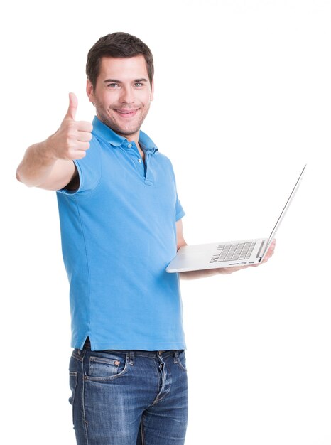Ritratto dell'uomo felice sorridente con il computer portatile dentro in camicia blu. Comunicazione di concetto.