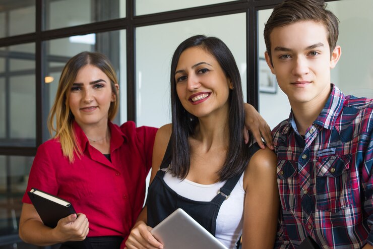 Foto gratuito ritratto di felice giovane studente amici abbracciando e sorridente