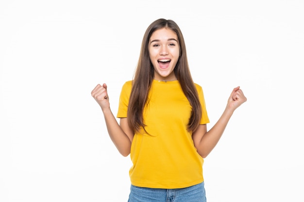 Ritratto di un'eccitata giovane donna che celebra il successo sul muro bianco