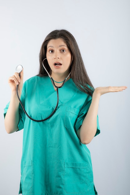 Ritratto di una giovane donna medico con stetoscopio in uniforme.