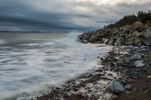 Rocky Shore Under Cloudy Sky