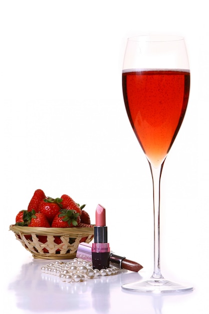 Rossetto rosa con bicchiere champagle rosso e fragola