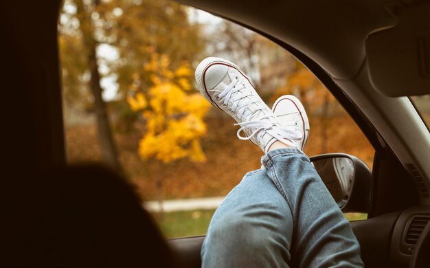 Scarpe da donna sul finestrino della macchina