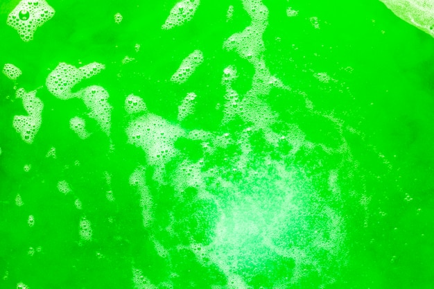 Schiuma e bolle su liquido colorato verde