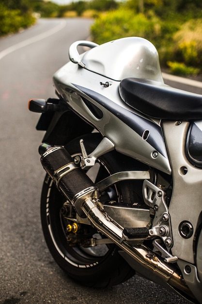 Sedile posteriore e ruota di una motocicletta color argento.