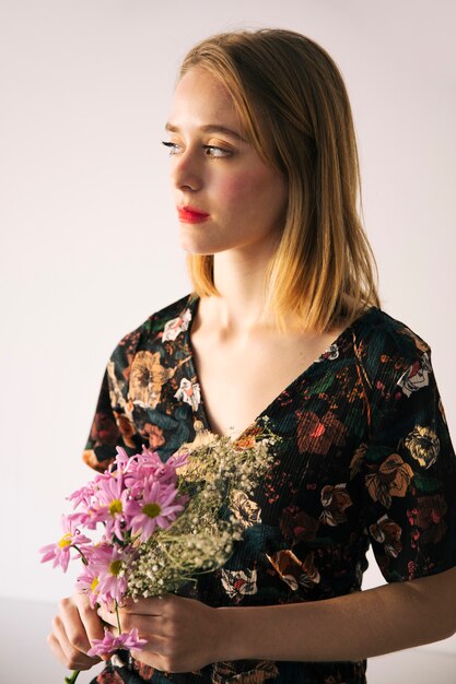 Sensuale donna adorabile con bouquet di fiori e piante