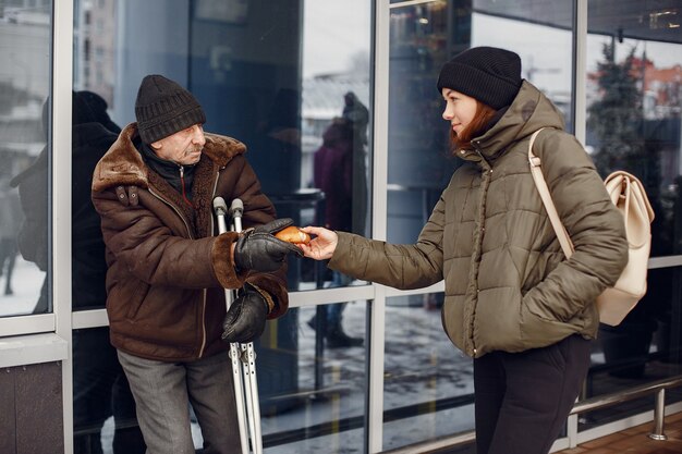 Senzatetto in una città invernale. Uomo che chiede cibo.