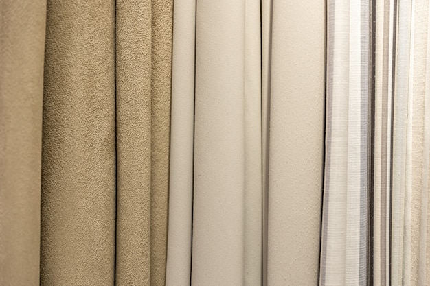 Set di tessuti densi pastello di consistenza uniforme, scelta di materiali nei colori beige.
