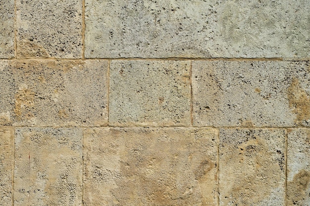 Sfondo del vecchio muro di pietra della decorazione interna della casa di arenaria o idea di design