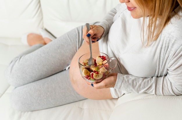 Signora incinta che mangia un'insalata