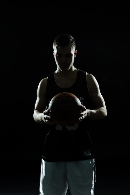 Silhouette di giocatore di basket con la palla