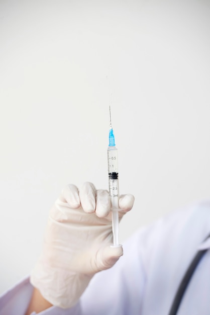 Siringa della holding del medico con il vaccino