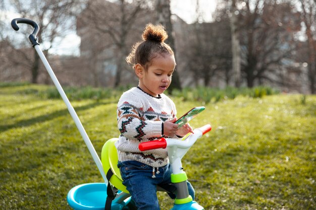 Smartphone della tenuta del bambino del colpo medio