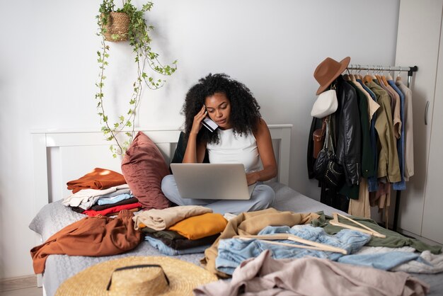 Smartphone della tenuta della donna della foto a figura intera