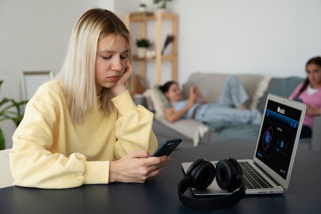 Smartphone triste della holding della ragazza di vista laterale